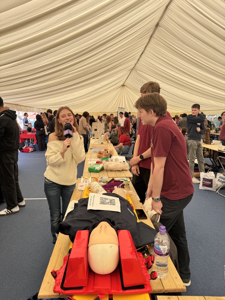 LSCFR members at Freshers' Fair stall with CPR mannequin and medical equipment on display